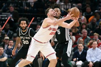 Jan 28, 2026; Houston, Texas, USA; San Antonio Spurs guard Stephon Castle (5) defends as Houston Rockets center Alperen Sengun (28) attempts to control the ball during the fourth quarter at Toyota Center. Mandatory Credit: Troy Taormina-Imagn Images