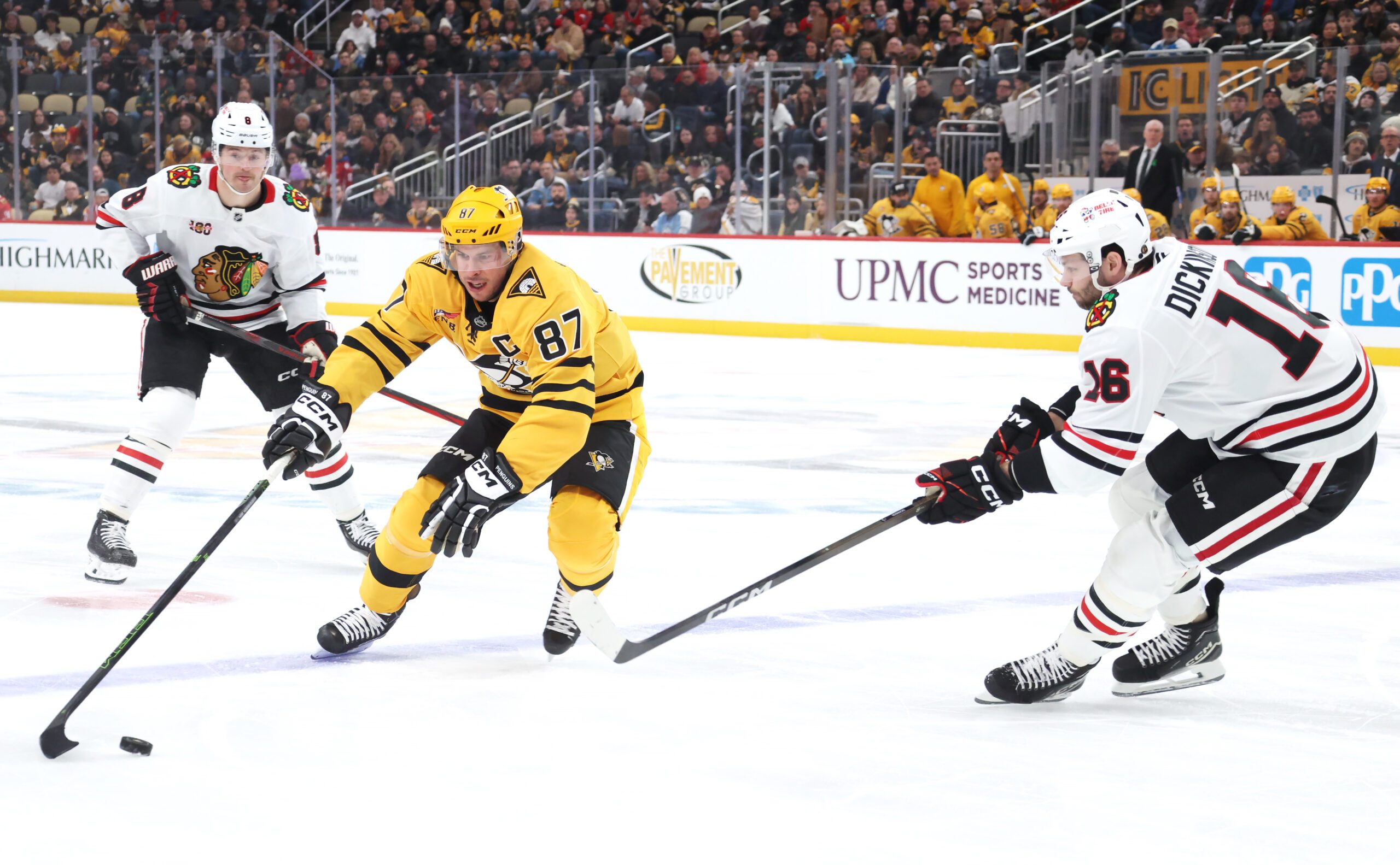 Jan 29, 2026; Pittsburgh, Pennsylvania, USA;  Pittsburgh Penguins center Sidney Crosby (87) gathers the puck against Chicago Blackhawks center Jason Dickinson (16) during the first period at PPG Paints Arena. Mandatory Credit: Charles LeClaire-Imagn Images