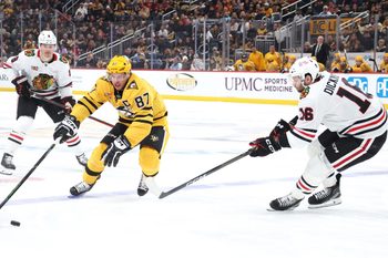 Jan 29, 2026; Pittsburgh, Pennsylvania, USA;  Pittsburgh Penguins center Sidney Crosby (87) gathers the puck against Chicago Blackhawks center Jason Dickinson (16) during the first period at PPG Paints Arena. Mandatory Credit: Charles LeClaire-Imagn Images