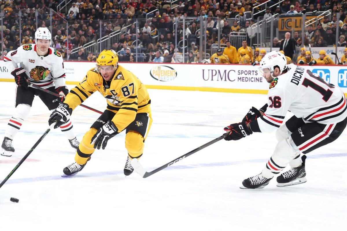 Jan 29, 2026; Pittsburgh, Pennsylvania, USA; Pittsburgh Penguins center Sidney Crosby (87) gathers the puck against Chicago Blackhawks center Jason Dickinson (16) during the first period at PPG Paints Arena. Mandatory Credit: Charles LeClaire-Imagn Images