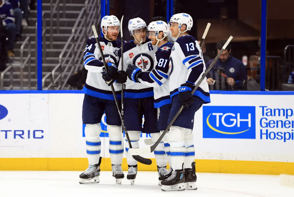 Jan 29, 2026; Tampa, Florida, USA; Winnipeg Jets left wing Kyle Connor (81) is congratulated by center Mark Scheifele (55) and defenseman Dylan Samberg (54) and center Gabriel Vilardi (13) after scoring a goal against the Tampa Bay Lightning during the second period at Benchmark International Arena. Mandatory Credit: Kim Klement Neitzel-Imagn Images