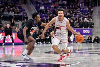 Jan 28, 2026; Fort Worth, Texas, USA; Houston Cougars guard Kingston Flemings (4) brings the ball up court past TCU Horned Frogs guard Jayden Pierre (1) during the game at Ed and Rae Schollmaier Arena. Mandatory Credit: Jerome Miron-Imagn Images