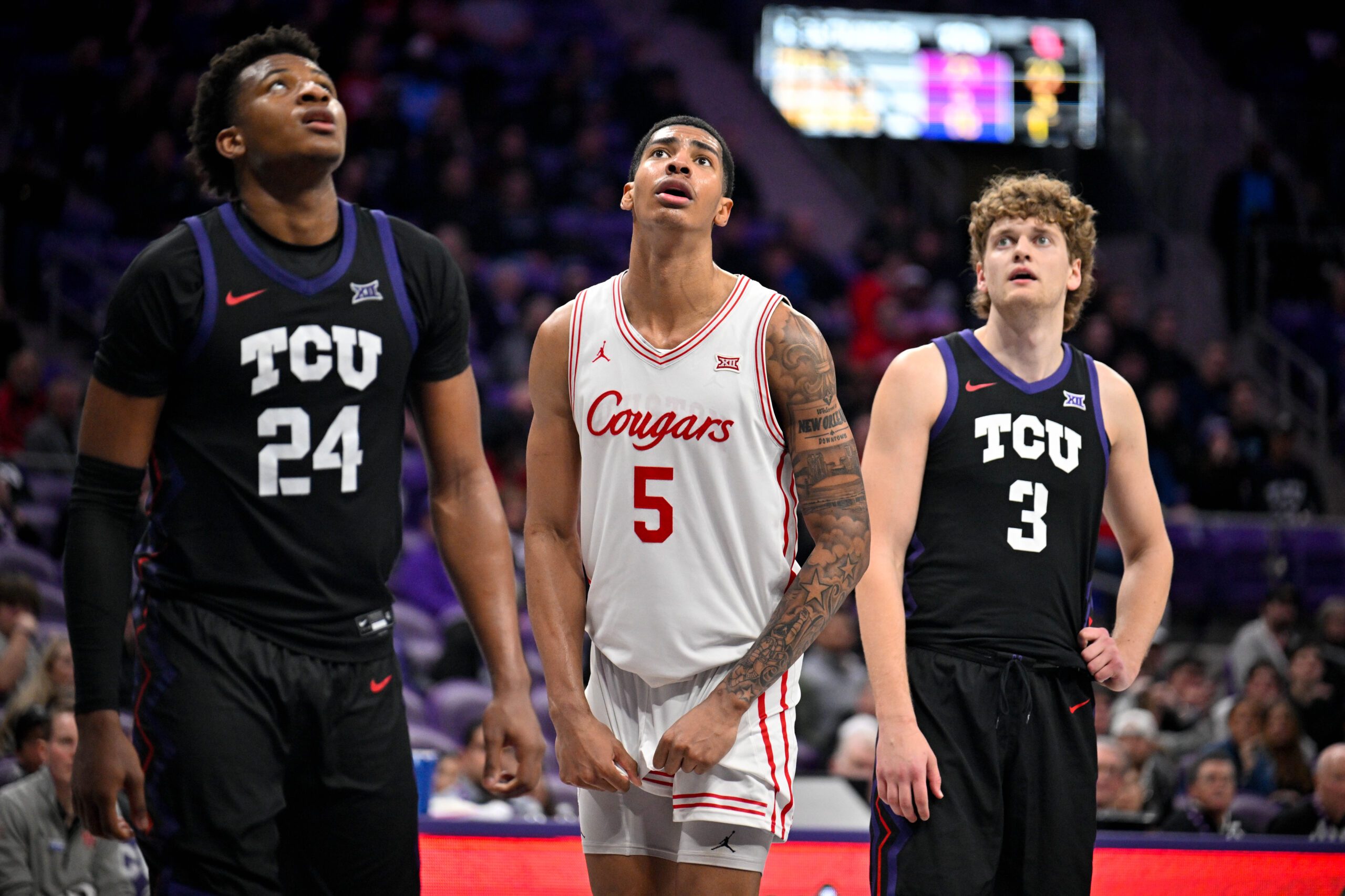 Jan 28, 2026; Fort Worth, Texas, USA; TCU Horned Frogs forward Xavier Edmonds (24) and guard Liutauras Lelevicius (3) and Houston Cougars forward Chris Cenac Jr. (5) look on during the game at Ed and Rae Schollmaier Arena. Mandatory Credit: Jerome Miron-Imagn Images