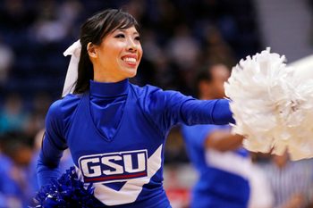 March 3, 2012; Richmond, VA USA; A Georgia State Panthers cheerleader dances on the court during a stoppage in play against the George Mason Patriots in the second half of their quarterfinal game of the 2012 Colonial Athletic Association tournament at the Richmond Coliseum. The Patriots won 61-59. Mandatory Credit: Geoff Burke-Imagn Images