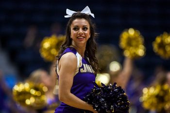 Mar 9, 2013; Richmond, VA, USA; A James Madison Dukes cheerleader preforms during a timeout against the William & Mary Tribe in the quarterfinals of the CAA Tournament at the Richmond Coliseum. Mandatory Credit: Peter Casey-Imagn Images