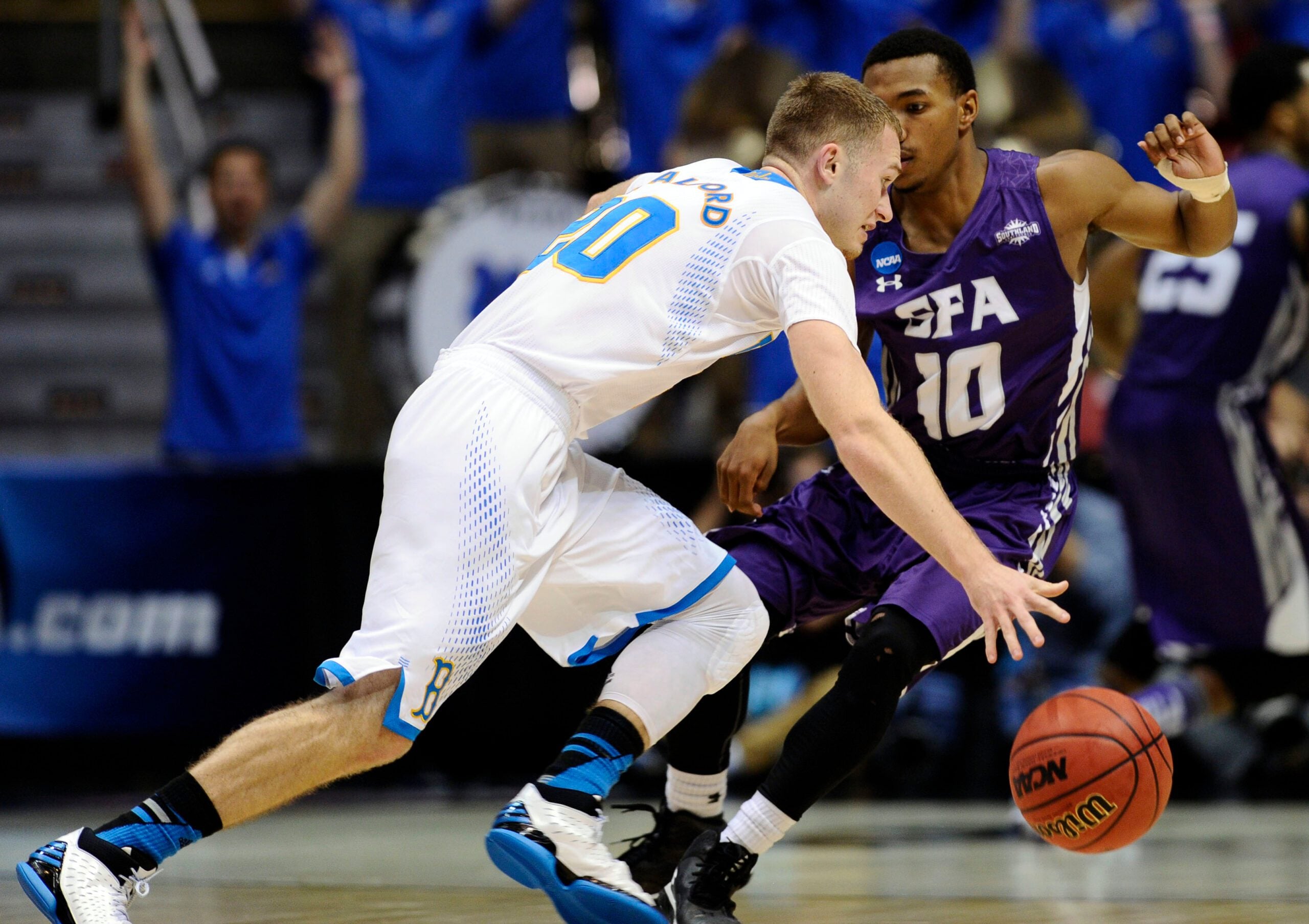 Mar 23, 2014; San Diego, CA, USA; UCLA Bruins guard Bryce Alford (20) drives against Stephen F. Austin Lumberjacks guard Trey Pinkney (10) in the second half of a men's college basketball game during the third round of the 2014 NCAA Tournament at Viejas Arena. Mandatory Credit: Robert Hanashiro-Imagn Images