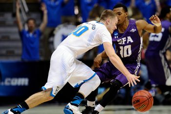 Mar 23, 2014; San Diego, CA, USA; UCLA Bruins guard Bryce Alford (20) drives against Stephen F. Austin Lumberjacks guard Trey Pinkney (10) in the second half of a men's college basketball game during the third round of the 2014 NCAA Tournament at Viejas Arena. Mandatory Credit: Robert Hanashiro-Imagn Images