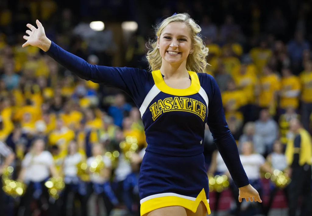 Dec 6, 2016; Philadelphia, PA, USA; A La Salle Explorers cheerleader waves to fans during the second half against the Villanova Wildcats at Palestra. The Villanova Wildcats won 89-79. Mandatory Credit: Bill Streicher-Imagn Images