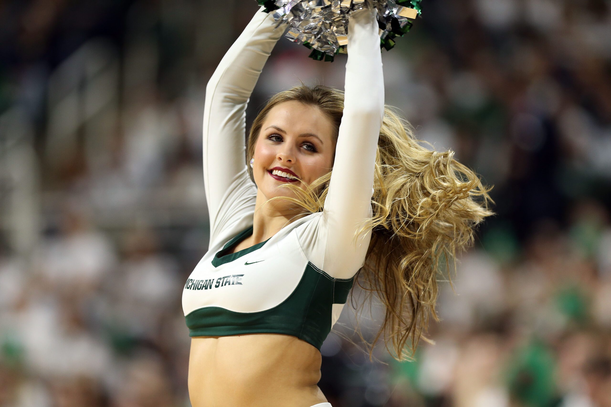 Jan 29, 2017; East Lansing, MI, USA; Michigan State Spartans cheerleader performs during the first half of a game between the Michigan State Spartans and the Michigan Wolverines at the Jack Breslin Student Events Center. Mandatory Credit: Mike Carter-Imagn Images