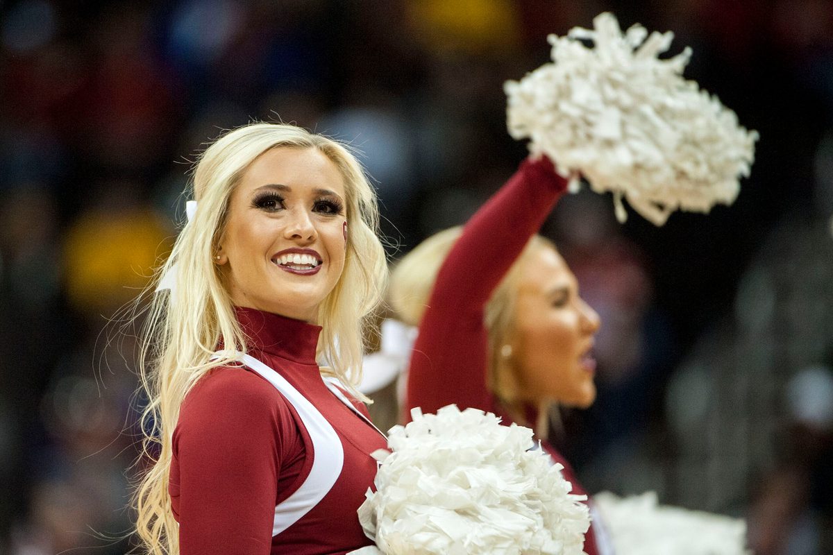 Mar 7, 2018; Kansas City, MO, United States; An Oklahoma Sooners cheerleader smiles during a timeout in the second half against the Oklahoma State Cowboys during the first round of the Big 12 Tournament at Sprint Center. Mandatory Credit: Amy Kontras-Imagn Images