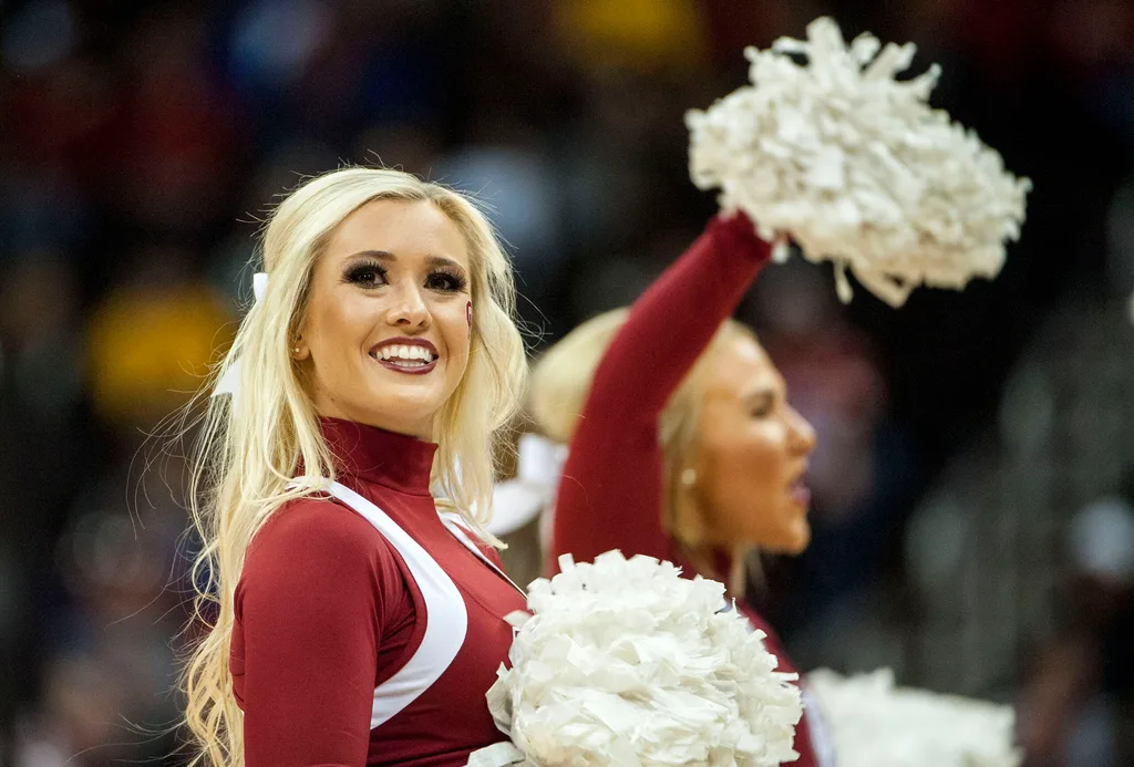 Mar 7, 2018; Kansas City, MO, United States; An Oklahoma Sooners cheerleader smiles during a timeout in the second half against the Oklahoma State Cowboys during the first round of the Big 12 Tournament at Sprint Center. Mandatory Credit: Amy Kontras-Imagn Images