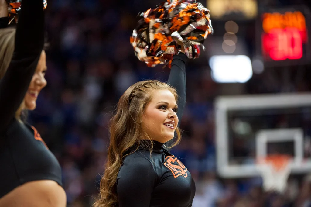 Mar 8, 2018; Kansas City, MO, United States; A Oklahoma State Cowboys cheerleader smiles in the first half against the Kansas Jayhawks during the semifinals of the Big 12 Tournament at Sprint Center. Mandatory Credit: Amy Kontras-Imagn Images