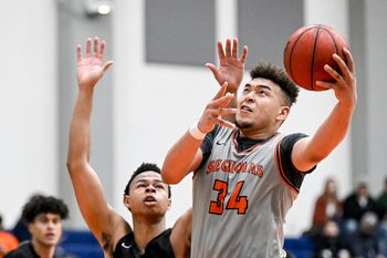 College of the Sequoias' Terri Miller shoots under pressure from Reedley's Justin Parks in men's basketball on Wednesday, February 9, 2022.