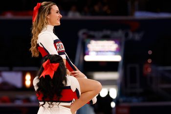 Mar 13, 2022; Washington, D.C., USA; Members of the Richmond Spiders cheerleaders cheer during a timeout against the Davidson Wildcats in the first half in the championship game of the Atlantic 10 conference at Capital One Arena. Mandatory Credit: Geoff Burke-Imagn Images