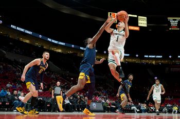 Nov 25, 2022; Portland, Oregon, USA; Portland State Vikings guard Cameron Parker (1) lays the ball up during the first half against West Virginia Mountaineers guard Joe Toussaint (5) at Moda Center. Mandatory Credit: Troy Wayrynen-Imagn Images