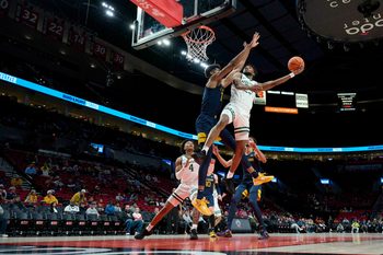 Nov 25, 2022; Portland, Oregon, USA; Portland State Vikings guard Jorell Saterfield (23) shoot a basket against West Virginia Mountaineers forward Mohamed Wague (11) during the first half at Moda Center. Mandatory Credit: Troy Wayrynen-Imagn Images