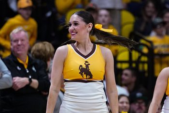 Jan 7, 2023; Laramie, Wyoming, USA; A Wyoming Cowboys cheerleader performs during their game against the San Diego State Aztecs during the second half at Arena-Auditorium. Mandatory Credit: Troy Babbitt-Imagn Images