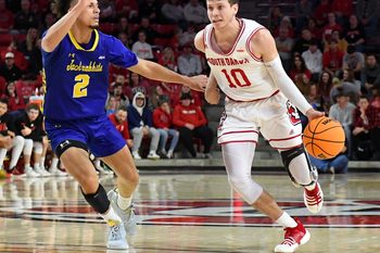 South Dakota   s A.J. Plitzuweit dribbles down the court while guarded by South Dakota State   s Zeke Mayo in a rivalry matchup on Saturday, January 14, 2023, at the Sanford Coyote Sports Center in Vermillion.

Men Rivalry Bball 004