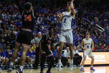 Waukee Northwest guard Cade Kelderman (2) takes a shot over Valley guard Trevian Carson (14) during the third quarter in the class 4A boys state basketball championship game at Wells Fargo Arena Friday, March 10, 2023, in Des Moines, Iowa.