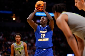 Mar 17, 2023; Denver, CO, USA;  UC Santa Barbara Gauchos forward Evans Kipruto (12) takes a shot at the basket during the first half against Baylor Bears in the first round of the 2023 NCAA men   s basketball tournament at Ball Arena. Mandatory Credit: Michael Ciaglo-Imagn Images