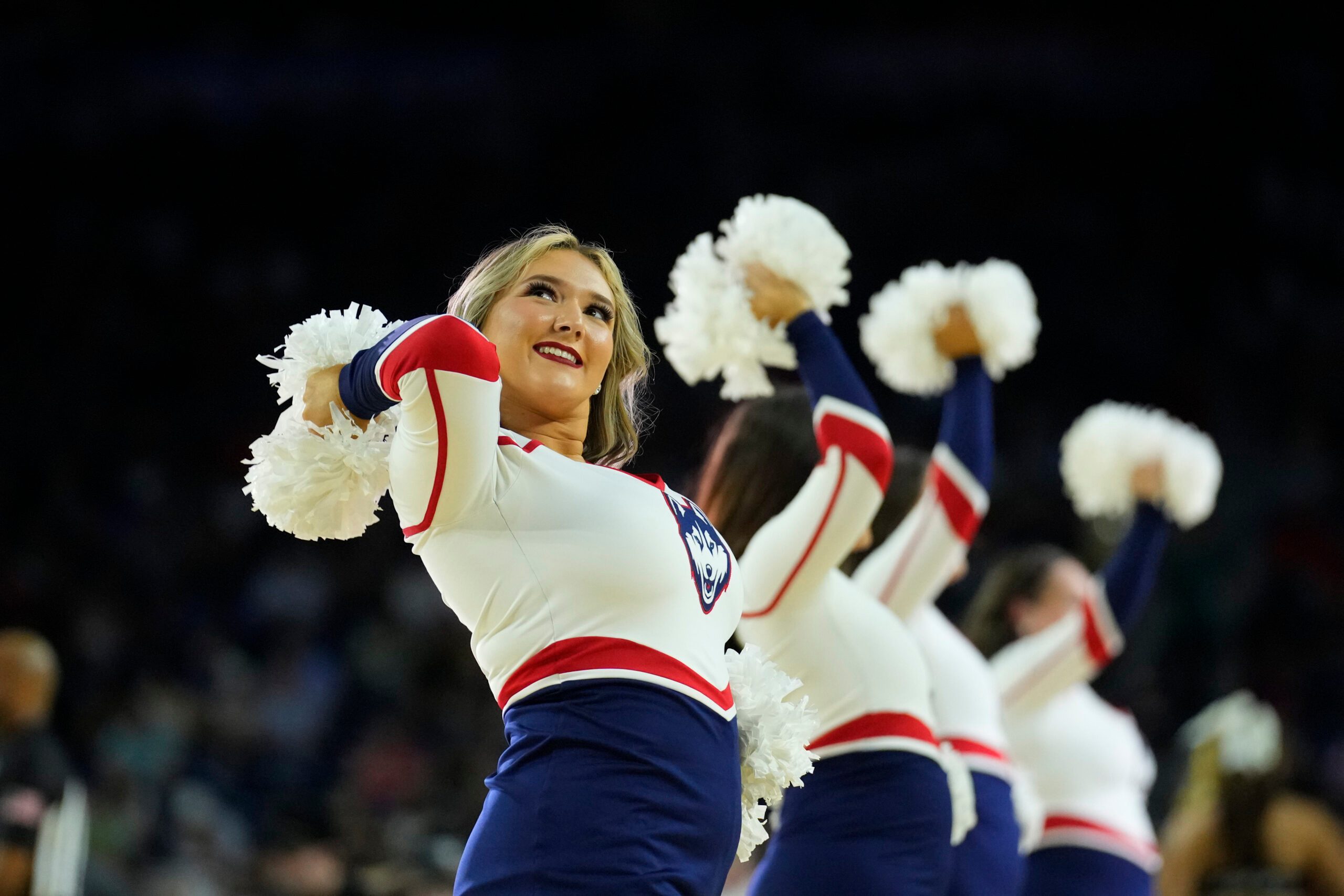 Apr 1, 2023; Houston, TX, USA; Connecticut Huskies cheerleaders perform against the Miami Hurricanes in the semifinals of the Final Four of the 2023 NCAA Tournament at NRG Stadium. Mandatory Credit: Robert Deutsch-Imagn Images