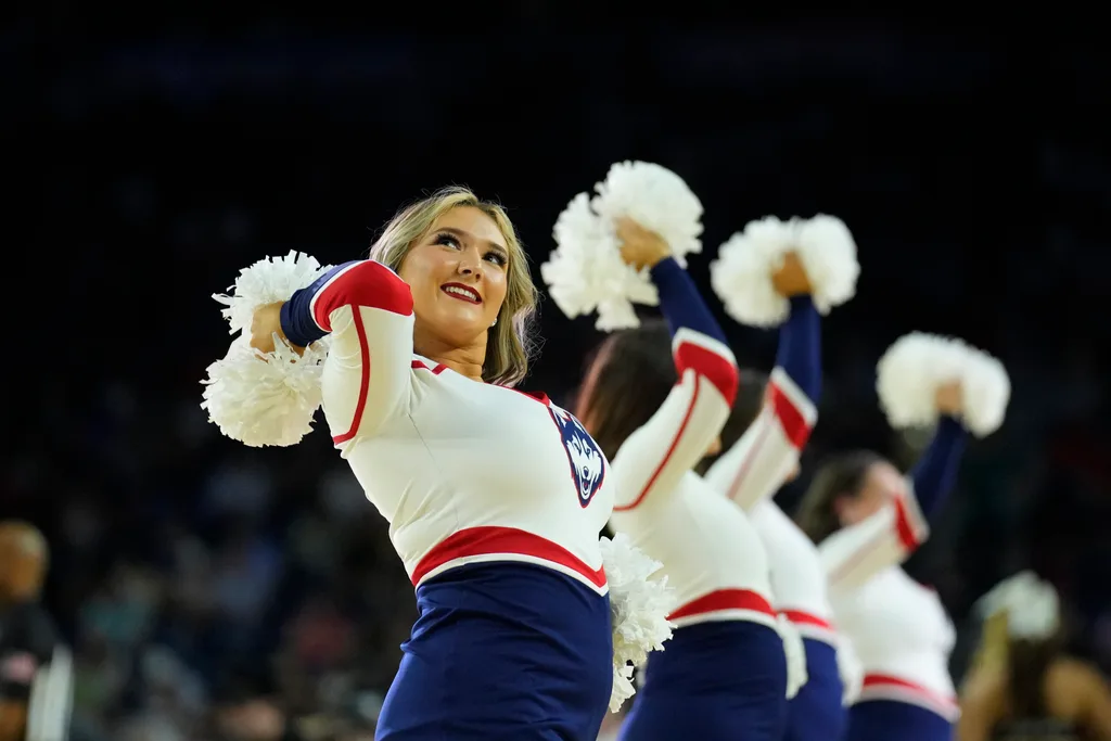 Apr 1, 2023; Houston, TX, USA; Connecticut Huskies cheerleaders perform against the Miami Hurricanes in the semifinals of the Final Four of the 2023 NCAA Tournament at NRG Stadium. Mandatory Credit: Robert Deutsch-Imagn Images