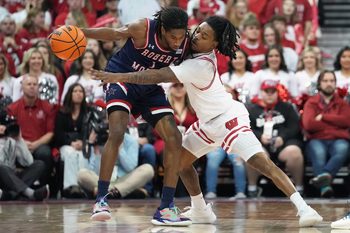 Nov 17, 2023; Madison, Wisconsin, USA; Wisconsin Badgers guard Kamari McGee (4) guards Robert Morris Colonials guard Justice Williams (1) during the second half at the Kohl Center. Mandatory Credit: Kayla Wolf-Imagn Images