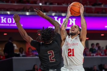 Dec 21, 2023; Houston, Texas, USA; Houston Cougars guard Emanuel Sharp (21) drives to the basket against Texas State Bobcats guard Dontae Horne (2) in the second half at Fertitta Center. Mandatory Credit: Thomas Shea-Imagn Images