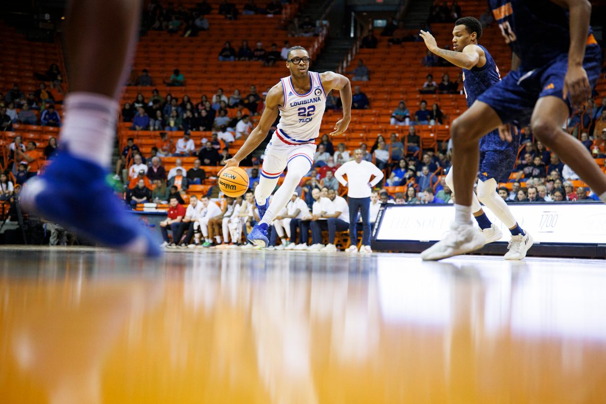 Feb 22, 2024; El Paso, Texas, USA; LA Tech Bulldogs Aggies forward Isaiah Crawford (22) dribbles the ball against the UTEP Miners defense in the first half at Don Haskins Center. Mandatory Credit: Ivan Pierre Aguirre-Imagn Images
