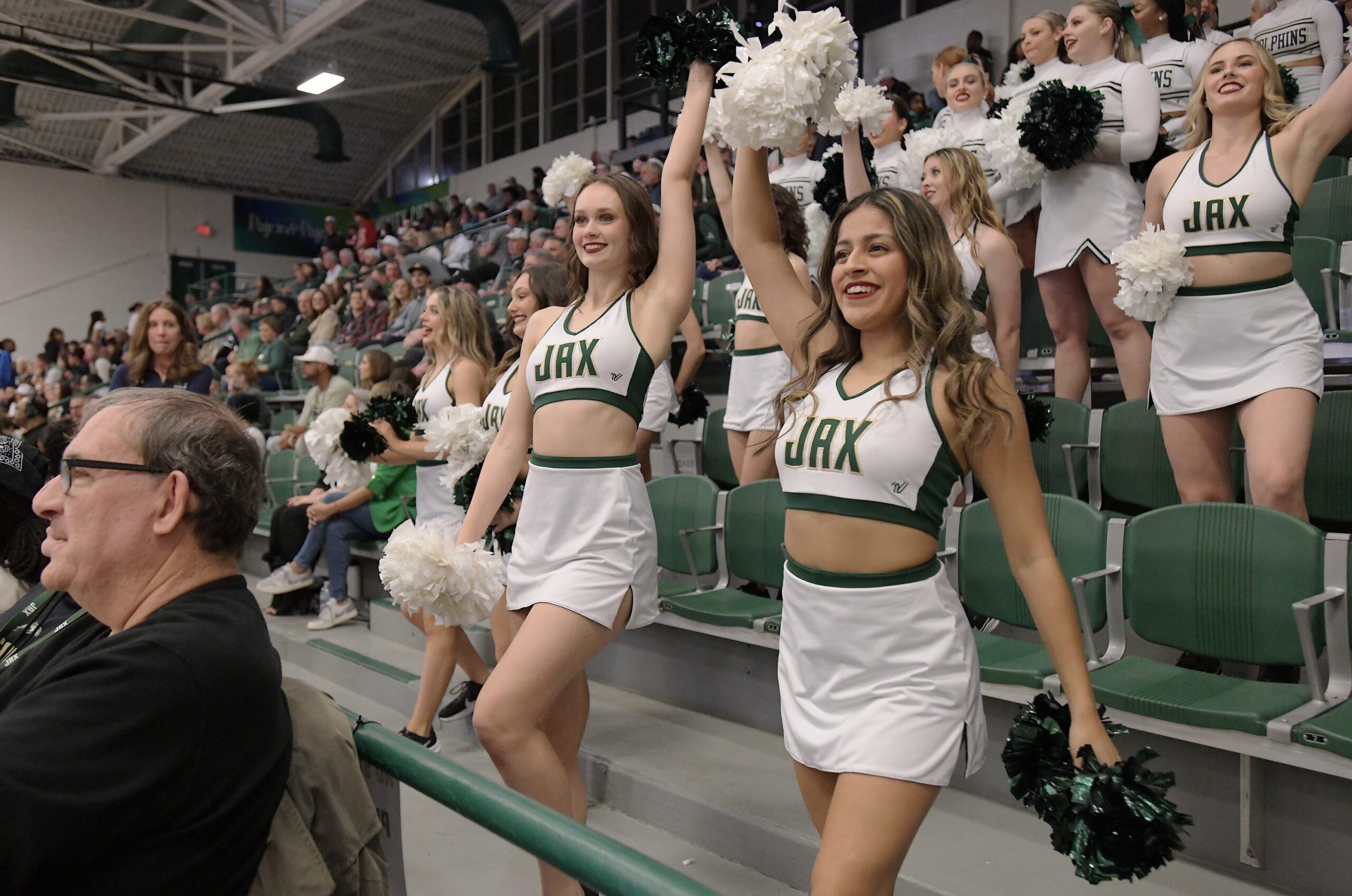 Jacksonville Dolphins cheerleaders in the stands during Friday night's game. Jacksonville University Dolphins hosted the University of North Florida Ospreys in Men's basketball in the historic Swisher Gym Friday night, February 23, 2024. The Ospreys led 25 to 23 at the half.