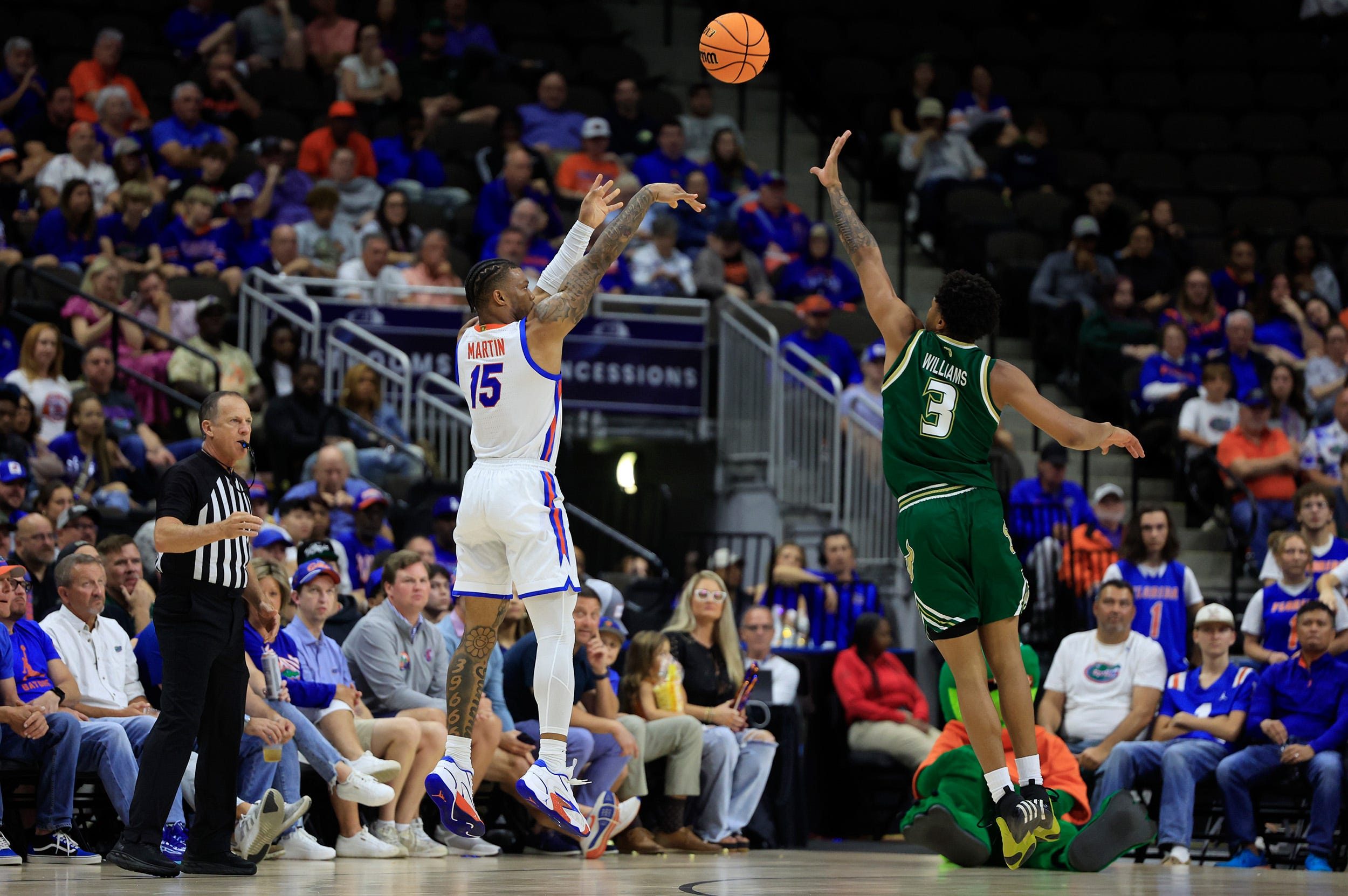 Florida Gators guard Alijah Martin (15) shoots past South Florida Bulls guard Jimmie Williams (3) during the second half of an NCAA men’s basketball matchup Monday, Nov. 4, 2024 at VyStar Veterans Memorial Arena in Jacksonville, Fla. Florida defeated South Florida 98-83. [Corey Perrine/Florida Times-Union]