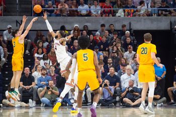 Vermont Catamounts guard TJ Hurley (3) shoots over Auburn Tigers forward Johni Broome (4) as Auburn Tigers take on Vermont Catamounts at Neville Arena in Auburn, Ala., on Wednesday, Nov. 6, 2024. Auburn Tigers leads Vermont Catamounts 46-21 at halftime.