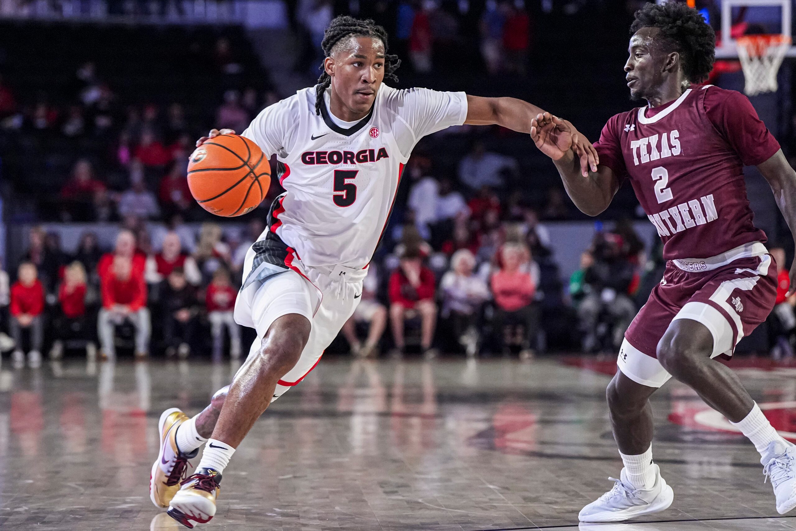 Nov 10, 2024; Athens, Georgia, USA; Georgia Bulldogs guard Silas Demary Jr. (5) dribbles against Texas Southern Tigers guard Kavion McClain (2) at Stegeman Coliseum. Mandatory Credit: Dale Zanine-Imagn Images
