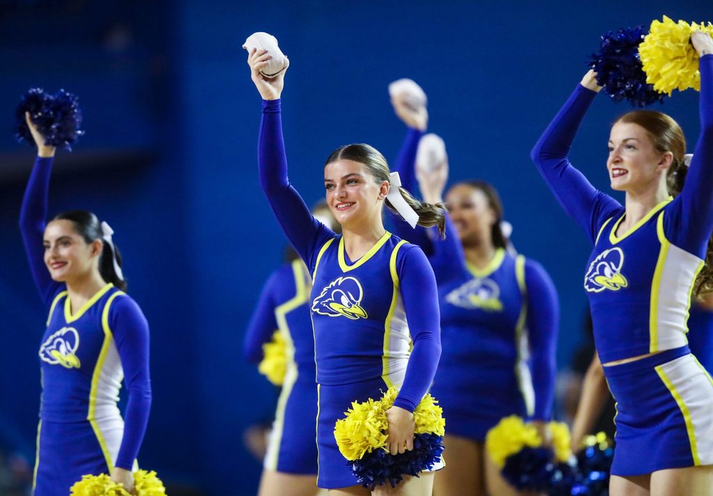 Delaware cheerleaders work in a timeout in the second half of the Blue Hens' 93-80 win against Delaware State at the Bob Carpenter Center, Tuesday, Dec. 3, 2024.