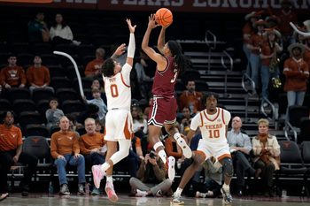Dec 12, 2024; Austin, Texas, USA; New Mexico State Aggies guard Christian Cook (3) shoots over guard Jordan Pope (0) during the second half at Moody Center. Mandatory Credit: Scott Wachter-Imagn Images