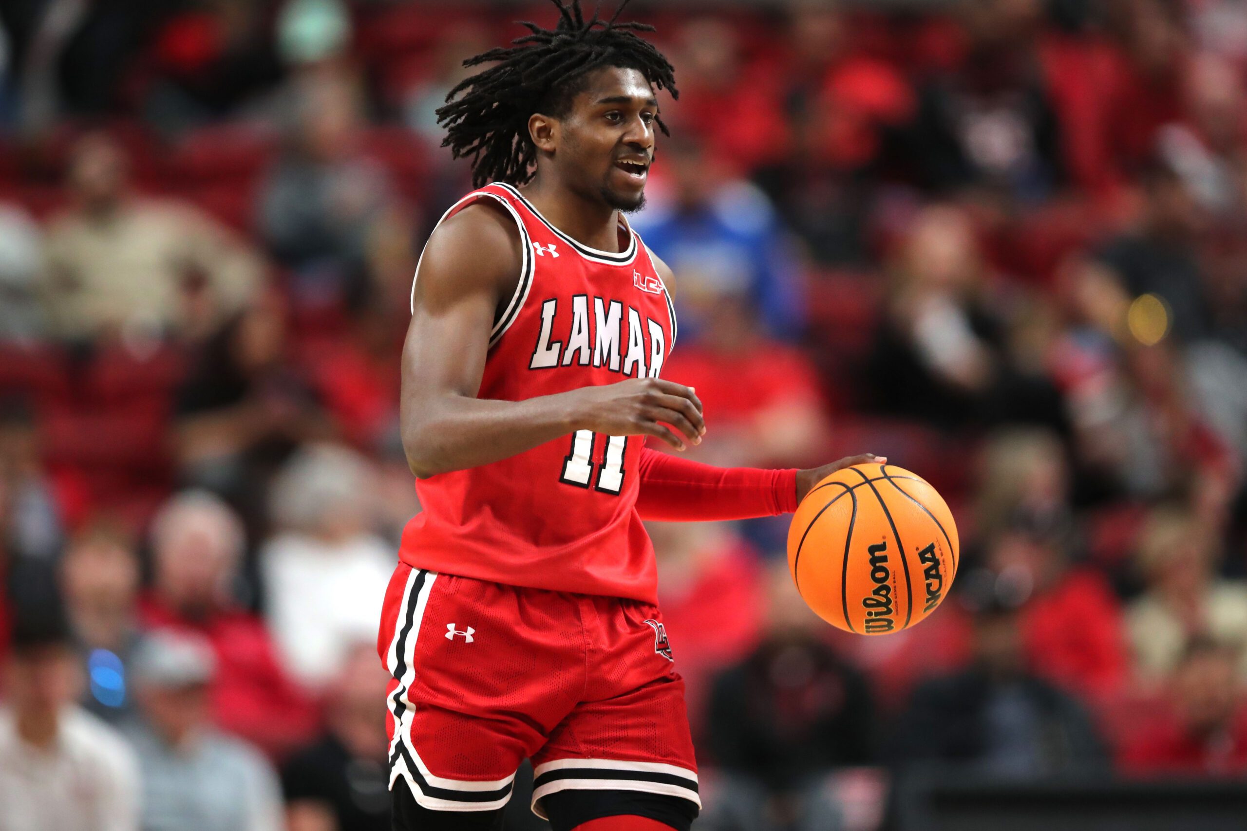 Dec 21, 2024; Lubbock, Texas, USA; Lamar Cardinals guard Ja”Sean Jackson (11) brings the ball up court against the Texas Tech Red Raiders in the second half at United Supermarkets Arena. Mandatory Credit: Michael C. Johnson-Imagn Images