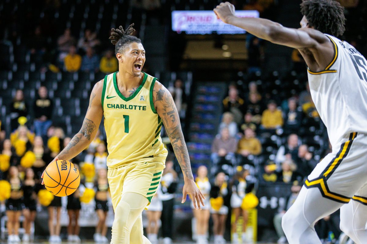 Jan 14, 2025; Wichita, Kansas, USA; Charlotte 49ers forward Giancarlo Rosado (1) brings the ball up court during the first half against the Wichita State Shockers at Charles Koch Arena. Mandatory Credit: William Purnell-Imagn Images