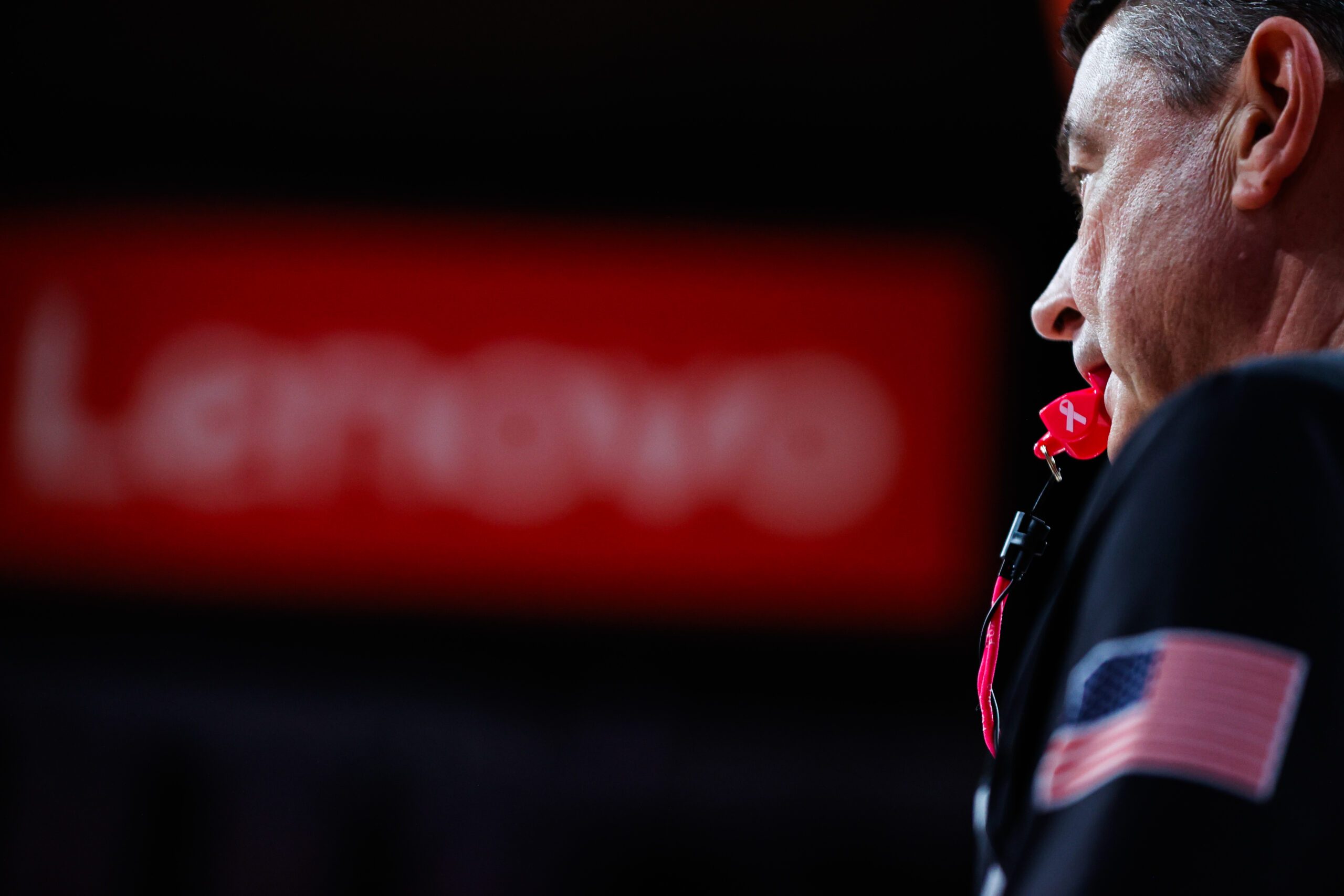 Feb 1, 2025; Raleigh, North Carolina, USA;  A referee with a pink whistle for Breast Cancer Awareness during the first half of the game North Carolina State Wolfpack against the Clemson Tigers at Lenovo Center. Mandatory Credit: Jaylynn Nash-Imagn Images