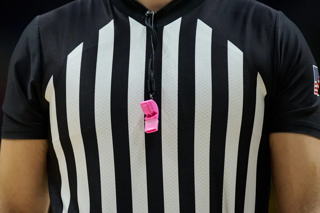 Feb 1, 2025; Berkeley, California, USA; Referee Mark Schnur wears a pink whistle to raise awareness for cancer research during the first half of the game between the California Golden Bears and the Syracuse Orange at Haas Pavilion. Mandatory Credit: Robert Edwards-Imagn Images