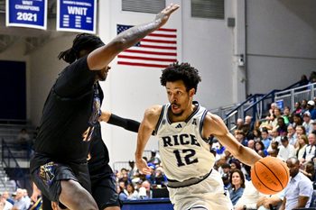 Feb 2, 2025; Houston, Texas, USA; Rice Owls guard Trae Broadnax (12) drives to the basket during the second half against the Memphis Tigers at Tudor Fieldhouse. Mandatory Credit: Maria Lysaker-Imagn Images