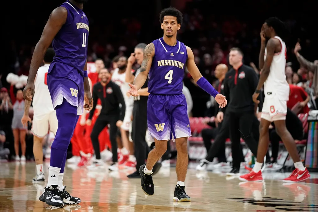 Washington Huskies guard DJ Davis (4) reacts during the NCAA men's basketball game against the Ohio State Buckeyes at Value City Arena in Columbus on Feb. 13, 2025. Ohio State won 93-69.