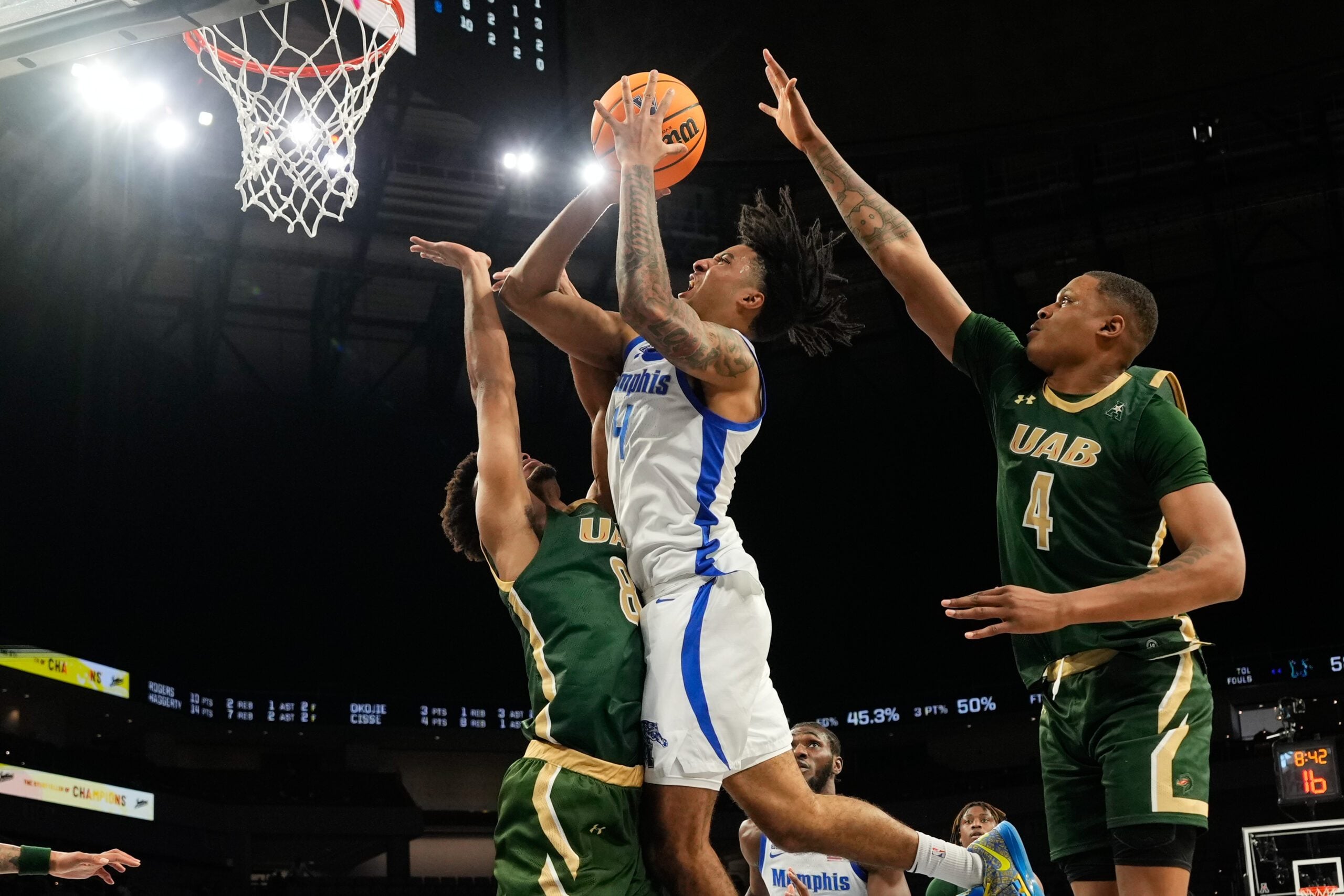 Mar 16, 2025; Fort Worth, TX, USA; Memphis Tigers guard PJ Haggerty (4) scores a basket over UAB Blazers guard Efrem Johnson (8) during the second half at Dickies Arena. Mandatory Credit: Chris Jones-Imagn Images