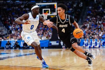 Mar 20, 2025; Denver, CO, USA; Brigham Young Cougars forward Mawot Mag (0) defends against VCU Rams forward Jack Clark (4) during the second half in the first round of the NCAA Tournament at Ball Arena. Mandatory Credit: Ron Chenoy-Imagn Images