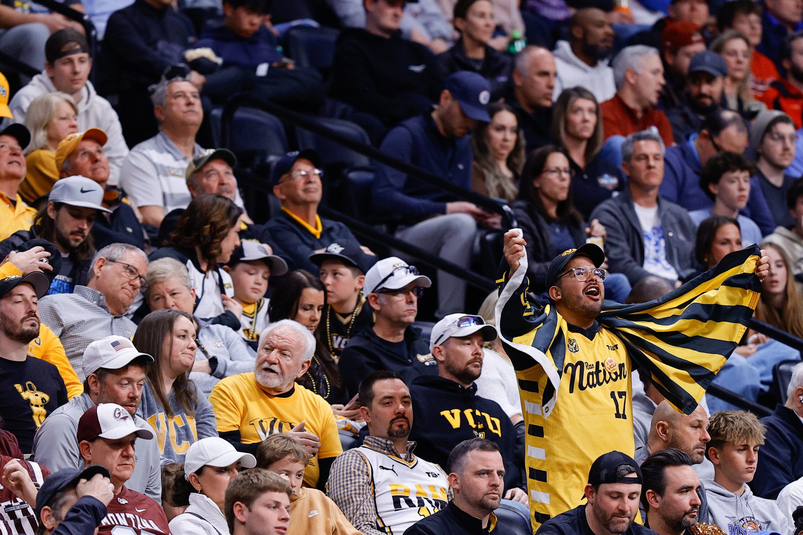 Mar 20, 2025; Denver, CO, USA; A fan for VCU Rams cheers during the second half against the Brigham Young Cougars in the first round of the NCAA Tournament at Ball Arena. Mandatory Credit: Isaiah J. Downing-Imagn Images