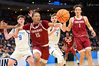 Mar 21, 2025; Milwaukee, WI, USA; Troy Trojans forward Jackson Fields (15) and Kentucky Wildcats forward Trent Noah (9) chase after a loose ball during the second half at Fiserv Forum. Mandatory Credit: Benny Sieu-Imagn Images