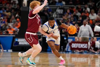 Mar 21, 2025; Milwaukee, WI, USA; Kentucky Wildcats guard Lamont Butler (1) drives to the hoop past Troy Trojans guard Cooper Campbell (3) during the second half at Fiserv Forum. Mandatory Credit: Jeff Hanisch-Imagn Images