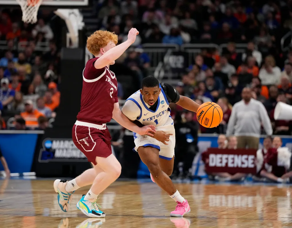 Mar 21, 2025; Milwaukee, WI, USA; Kentucky Wildcats guard Lamont Butler (1) drives to the hoop past Troy Trojans guard Cooper Campbell (3) during the second half at Fiserv Forum. Mandatory Credit: Jeff Hanisch-Imagn Images