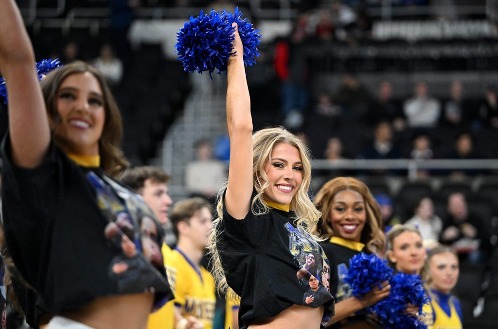 Mar 22, 2025; Providence, RI, USA; McNeese State Cowboys cheerleaders wear shirts with McNeese State Cowboys manager Amir Khan (not pictured) before a second round men’s NCAA Tournament game against the Purdue Boilermakers at Amica Mutual Pavilion. Mandatory Credit: Brian Fluharty-Imagn Images