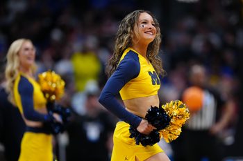 Mar 22, 2025; Denver, CO, USA; Michigan Wolverines cheerleaders perform during the first half in the second round of the NCAA Tournament  at Ball Arena. Mandatory Credit: Ron Chenoy-Imagn Images