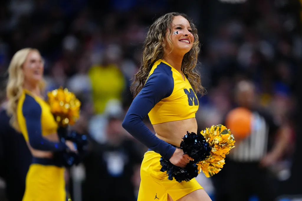 Mar 22, 2025; Denver, CO, USA; Michigan Wolverines cheerleaders perform during the first half in the second round of the NCAA Tournament at Ball Arena. Mandatory Credit: Ron Chenoy-Imagn Images